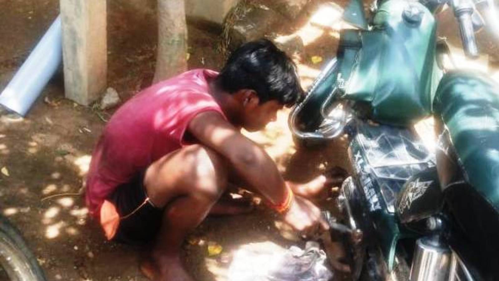 A child labourer in a mechanic shop